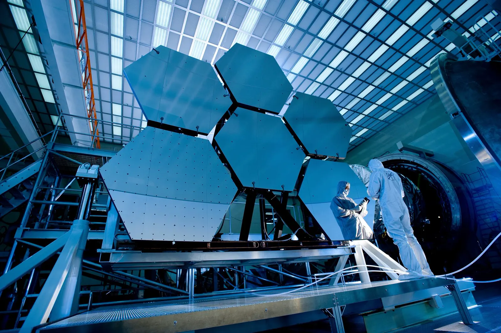 Technicians assembling a hexagonal space-telescope mirror array