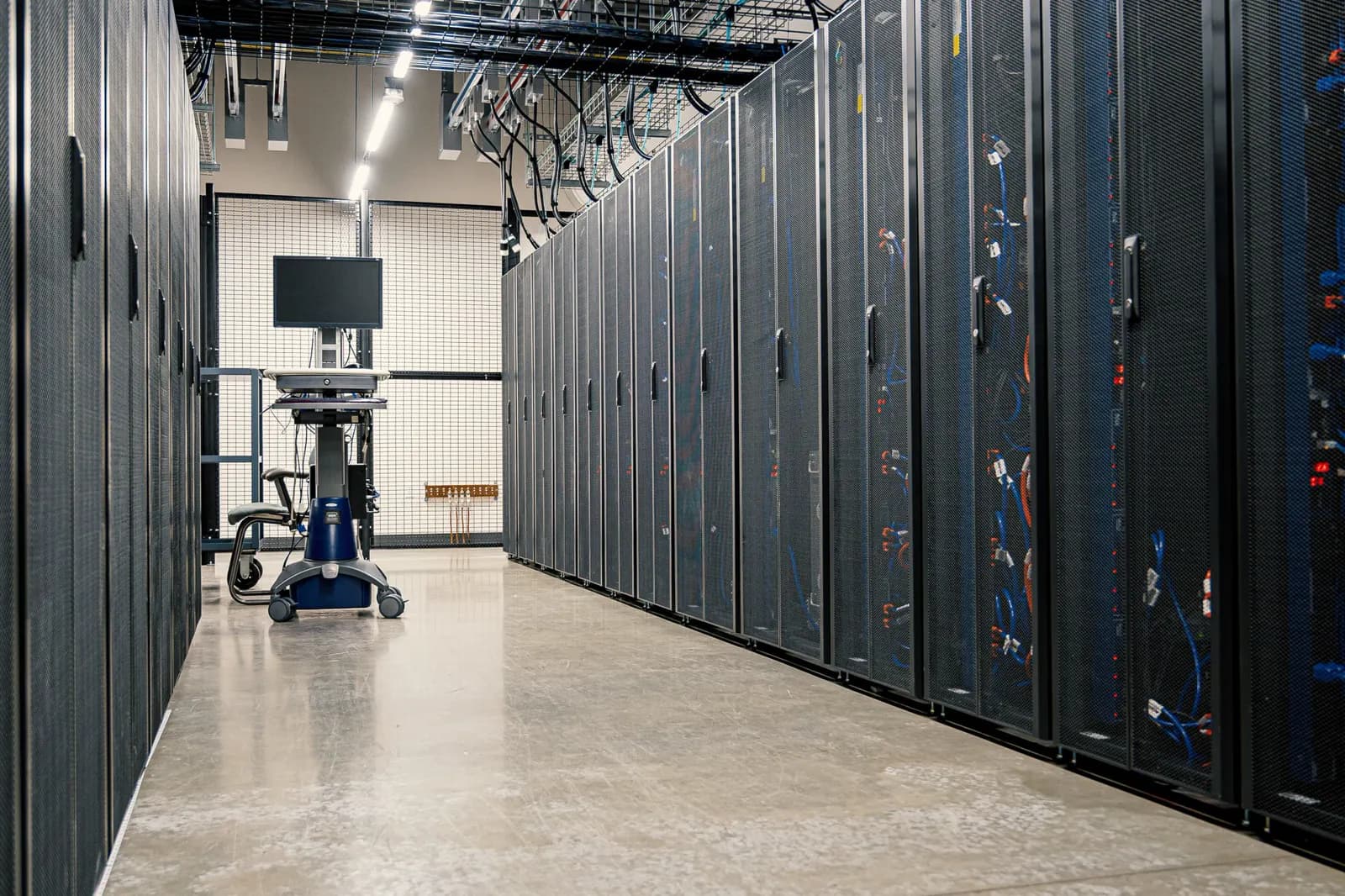 Aisle of server racks in a modern data centre